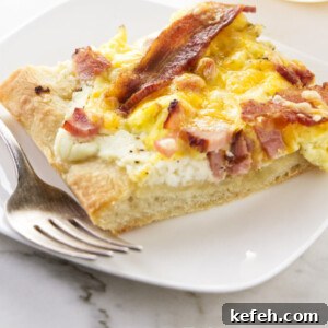 A slice of breakfast pizza on a serving plate.