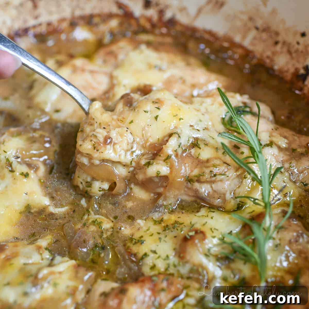 French Onion Chicken Casserole with Melted Gruyère 8 a spoon in french onion chicken bake.