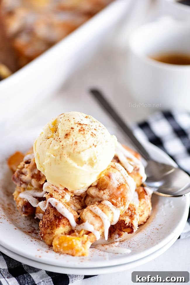 Cinnamon Roll Peach Cobbler with a scoop of ice cream