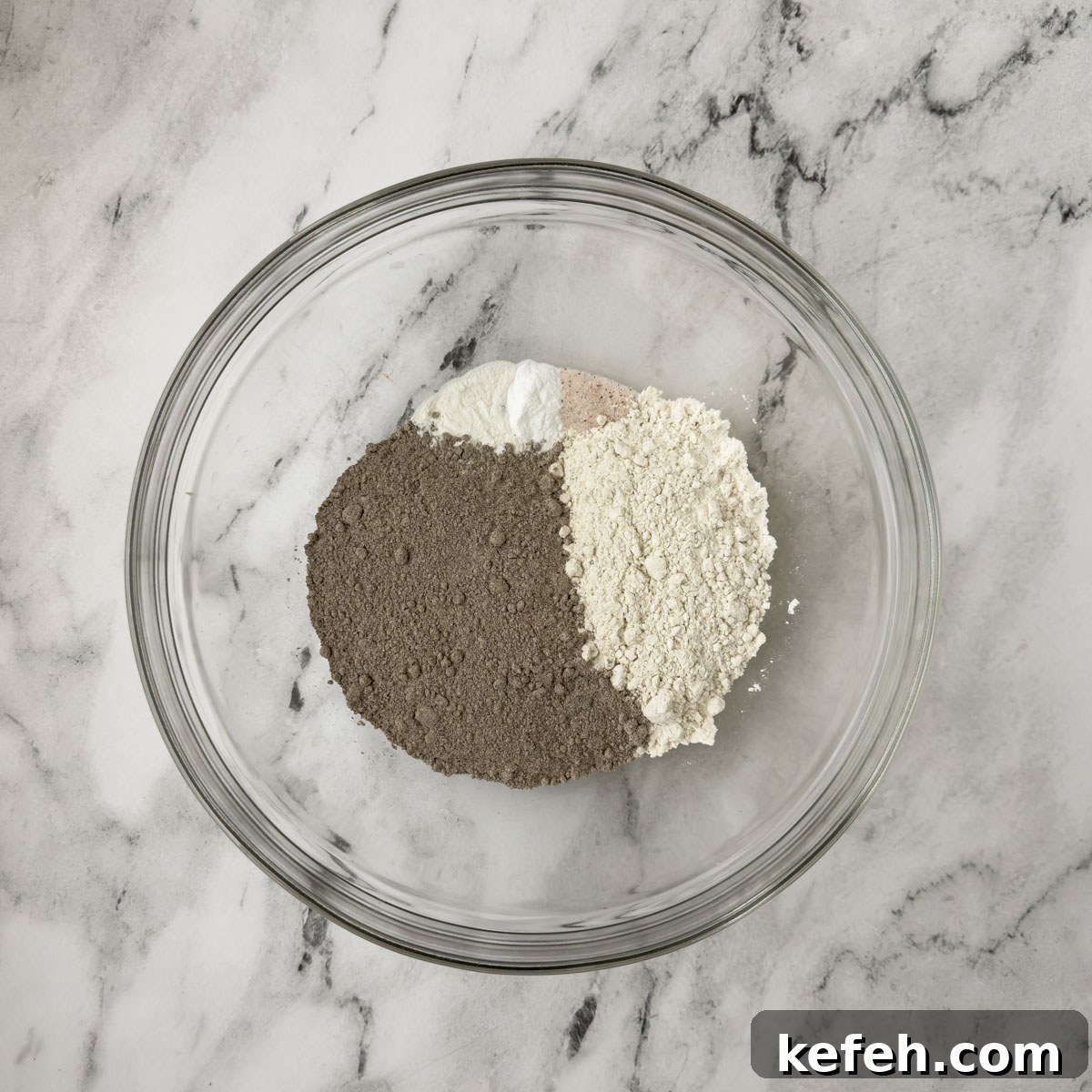 Dry ingredients for pancakes in a glass mixing bowl.