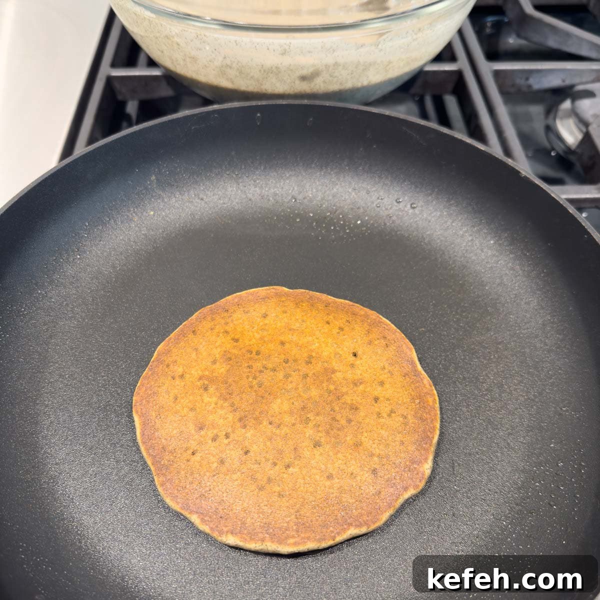 A golden buckwheat pancake finished in the pan.