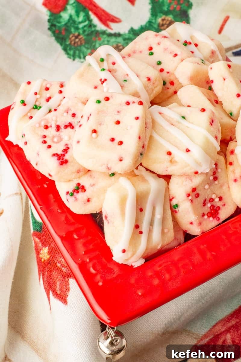 Christmas shortbread bites in red container.