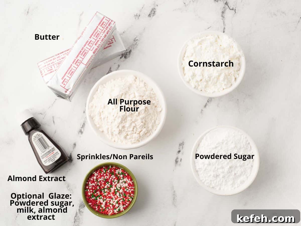 Labelled ingredients for Christmas shortbreda bites on marble board.