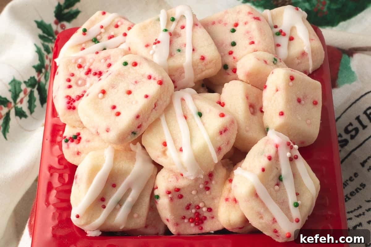 Christmas shortbread bites in red container.