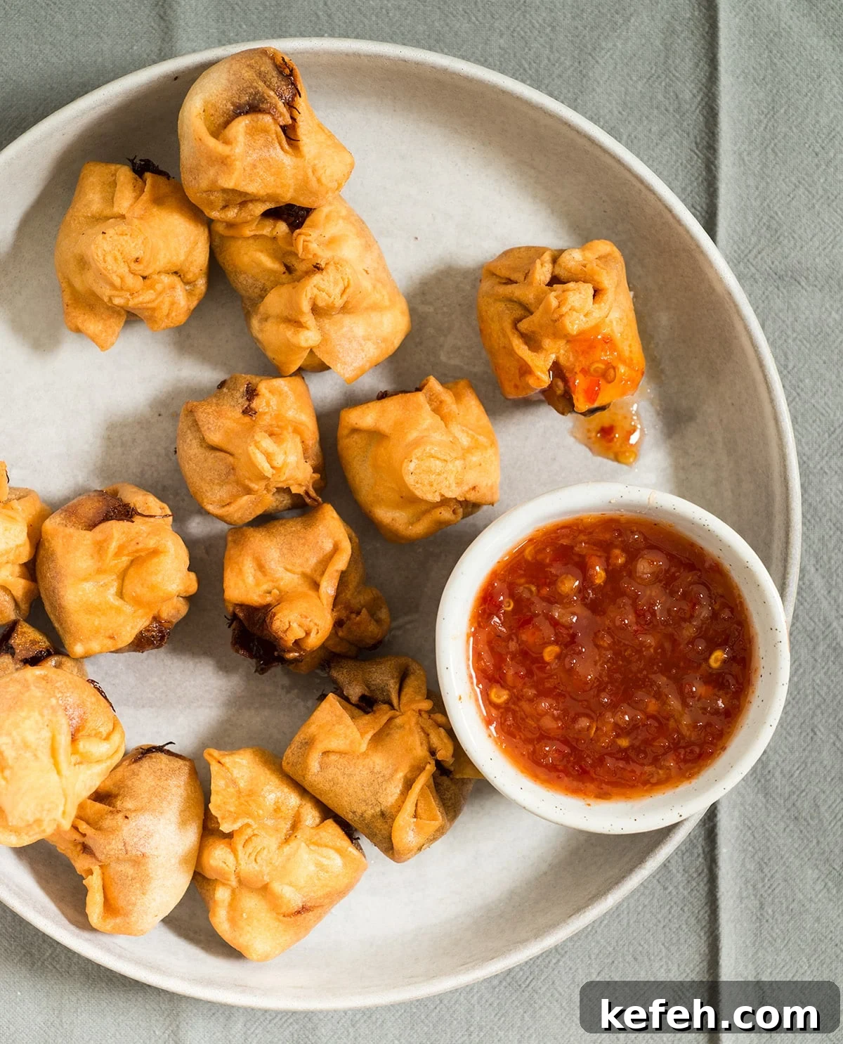 Gluten-Free Crab Rangoon Recipe: Crispy Homemade Appetizers 2 gluten free crab rangoon on plate with dipping sauce