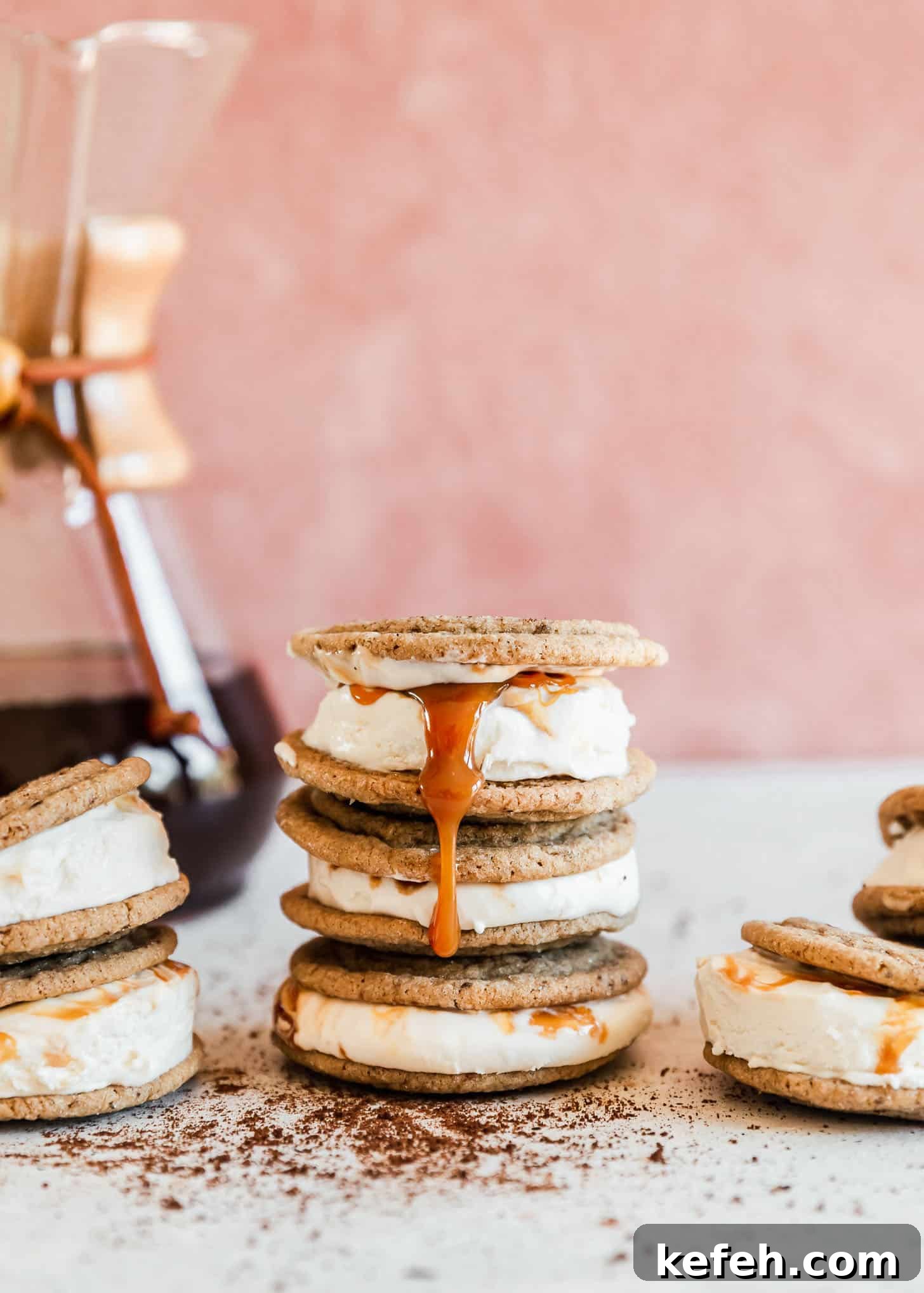 Salted Caramel Coffee Ice Cream Sandwiches Recipe 8 A drizzle of caramel running down a stack of coffee ice cream sandwiches on a pink and white backdrop.