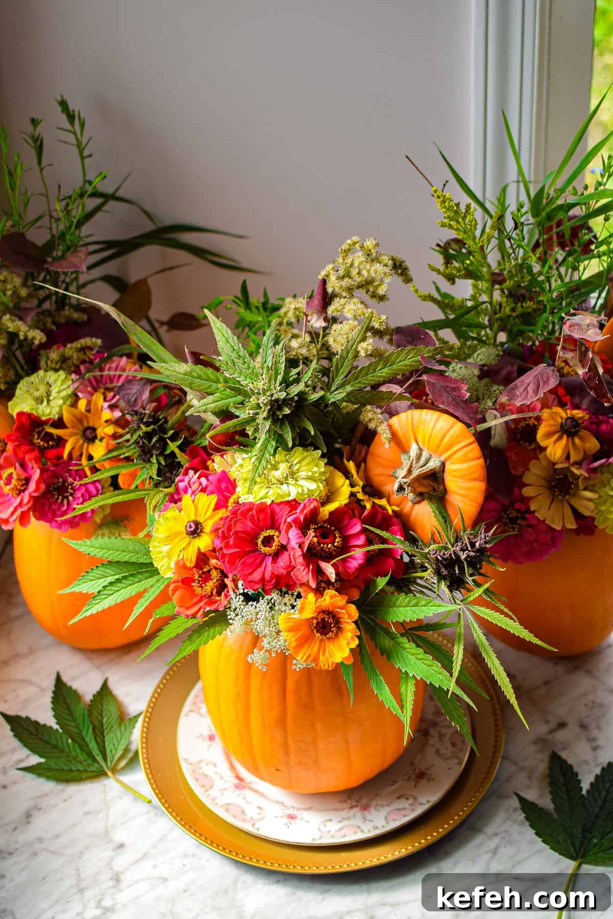 Cannabis-Inspired Fall Centerpiece Ideas for Seasonal Decor 3 A pumpkin on a plate with flowers coming out the top to create a cannabis fall centerpiece