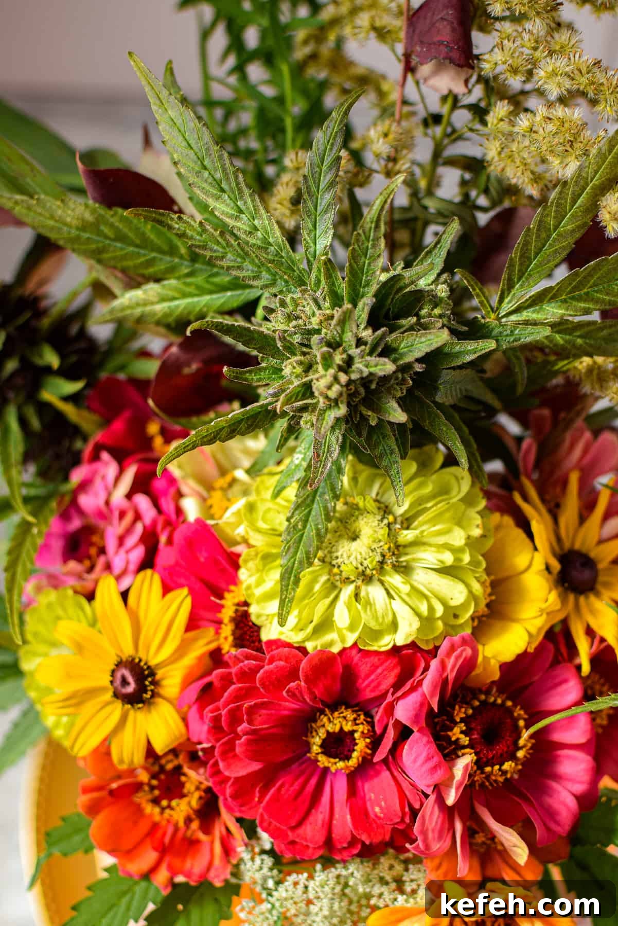 Cannabis-Inspired Fall Centerpiece Ideas for Seasonal Decor 7 A bouquet of flowers including zinnias and cannabis flowers