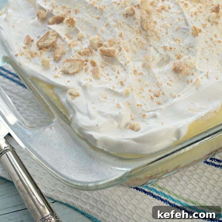 Fluffy cool whip on the top with a kitchen towel in the background