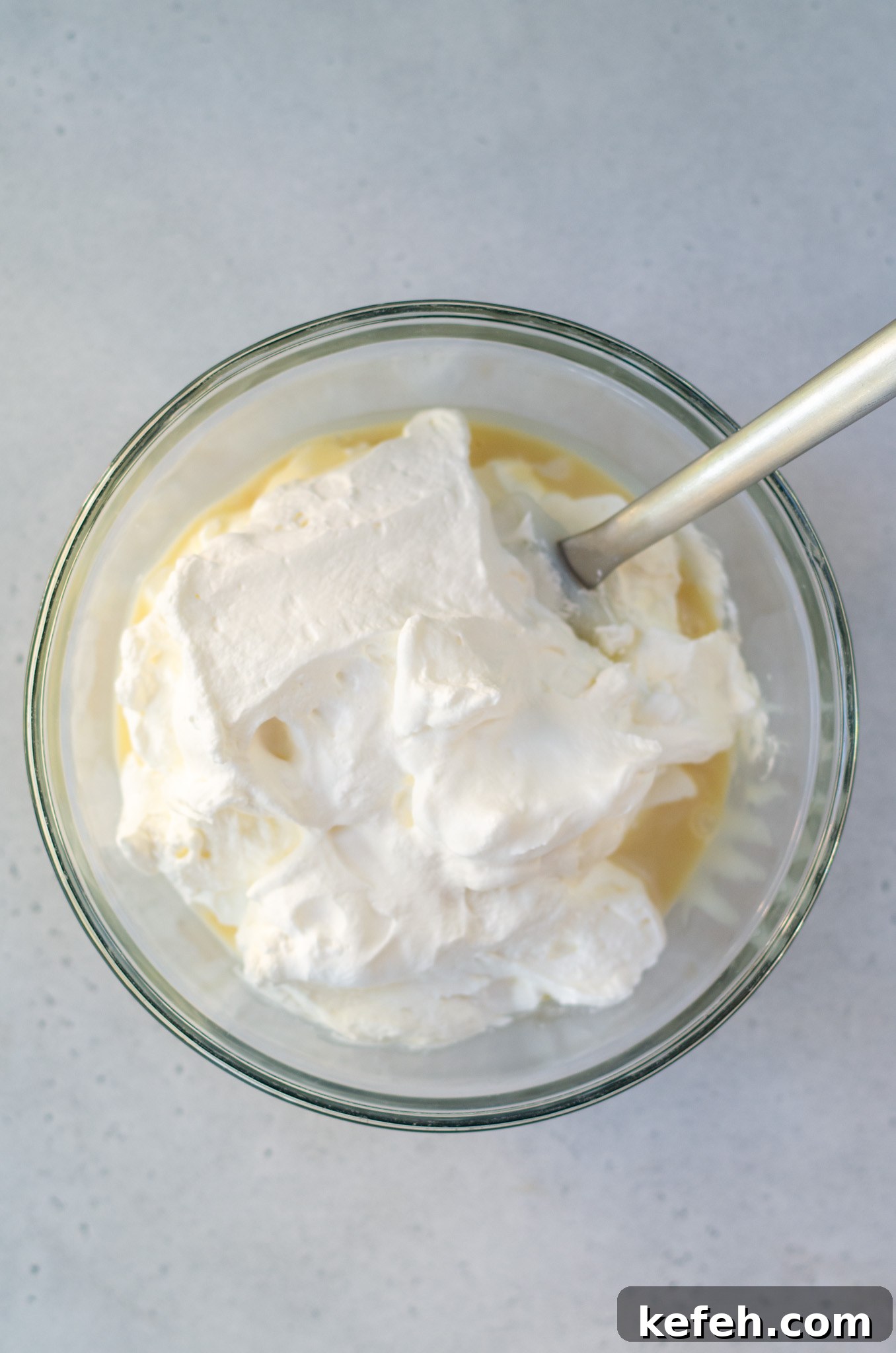 sweetened condensed milk and whipped cream in a bowl