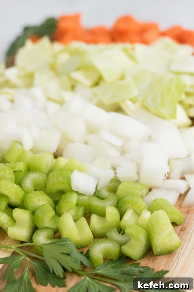 Hearty Vegan Cabbage Soup Recipe with Savory Herbs 3 vegan cabbage soup- ingredients for the soup chopped up and lined up in a row