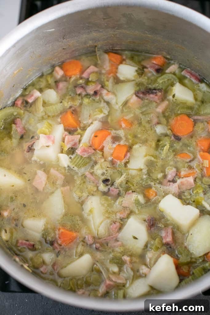 Creamy Split Pea Soup Recipe with Ham and Carrots 7 making split pea soup in a large pot