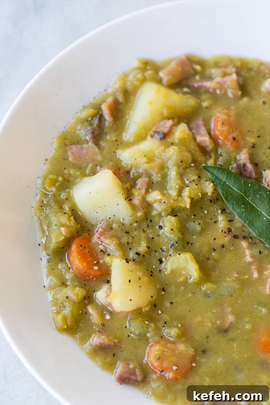Creamy Split Pea Soup Recipe with Ham and Carrots 9 split pea soup in a white bowl