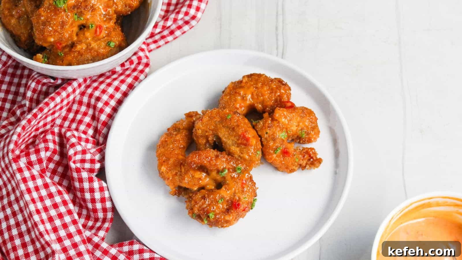 30 Seafood Recipes That Turn Weeknights Into a Vacation 21 Fried shrimp on a plate next to a bowl of sauce.
