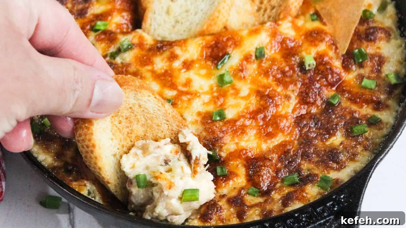 30 Seafood Recipes That Turn Weeknights Into a Vacation 26 A person dipping a piece of bread into a skillet of cheesy dip.