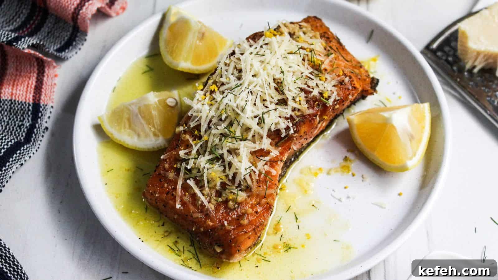 30 Seafood Recipes That Turn Weeknights Into a Vacation 9 A plate of salmon on a white plate with lemon slices on it.