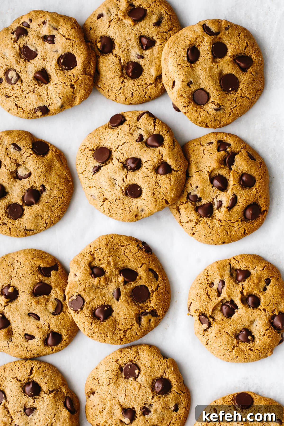 25+ Unique Thanksgiving Dessert Ideas to Impress Your Guests 7 Gluten-free chocolate chip cookies spread out on a baking sheet.