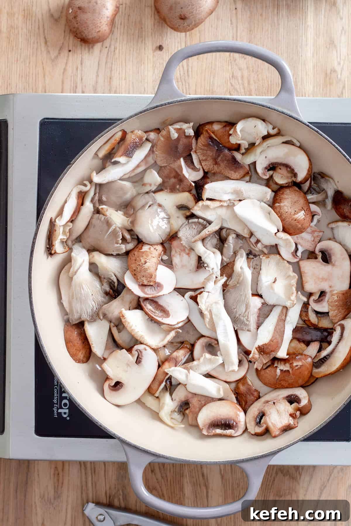 Various sliced mushrooms cooking in a large skillet for homemade mushroom pappardelle.