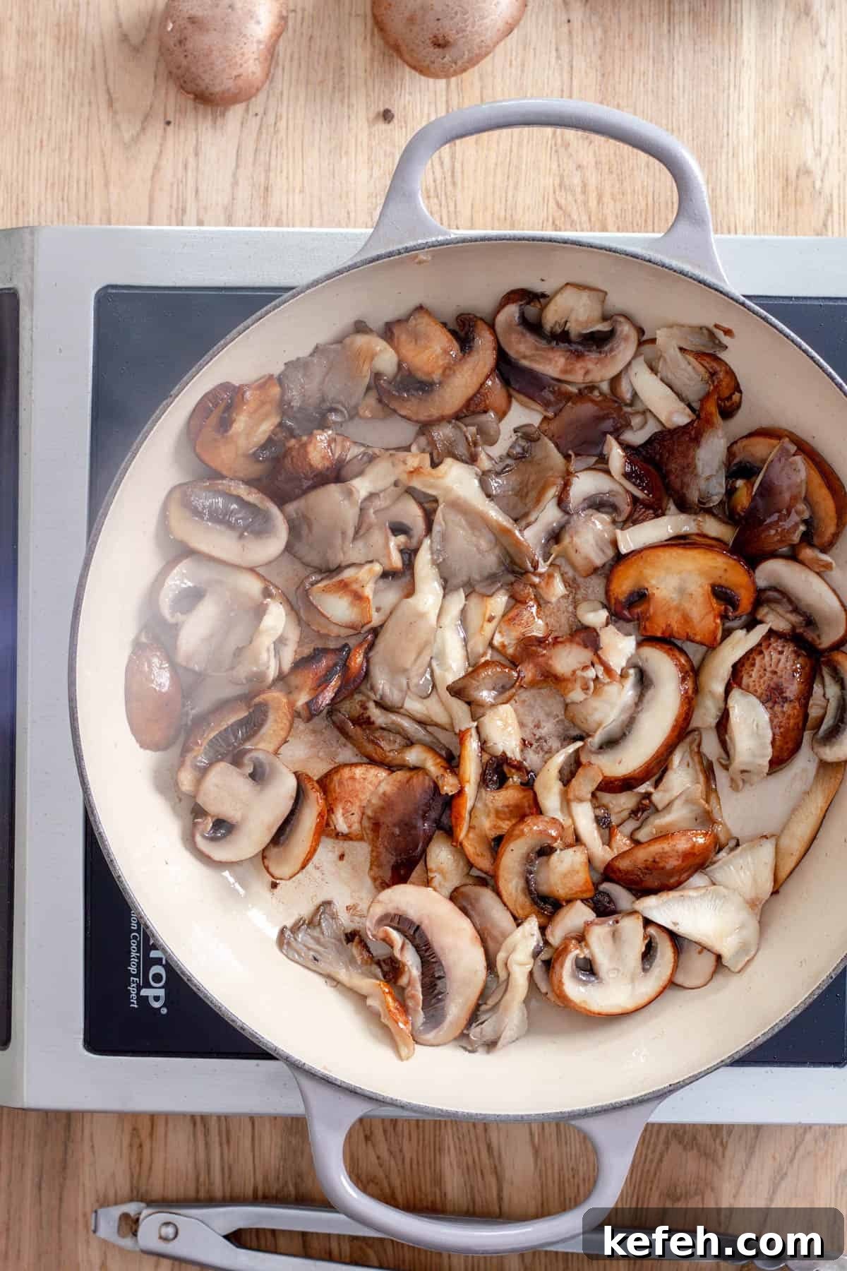 Seared mushrooms in a large skillet.
