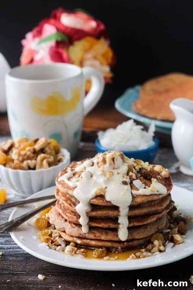 Carrot cake pancakes drizzled with sweet cashew cream cheese frosting.