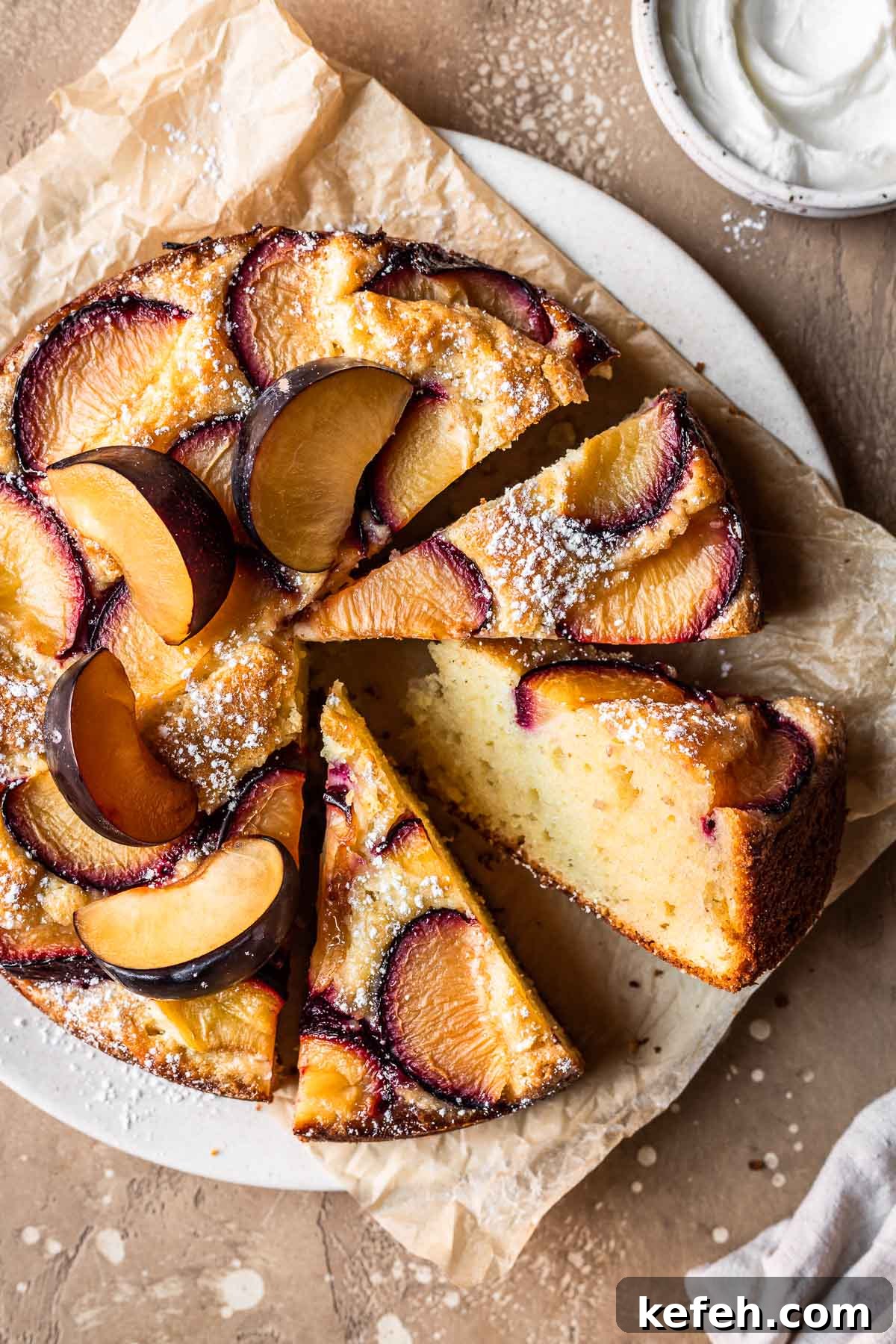 A close up photo of plum cake with several slices cut and turned to the side.
