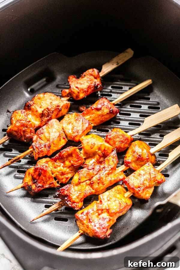Crispy Air Fryer Chicken Satay with Peanut Dipping Sauce 4 Chicken satay in an Air Fryer on a grill pan. Ready to serve as a side dish with fried rice or with some fries or bread.