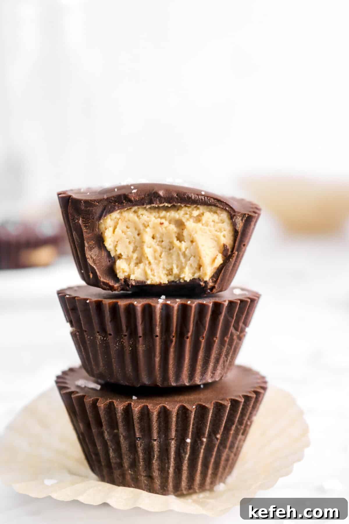 close up of three stacked peanut butter cups with a bite out of one.