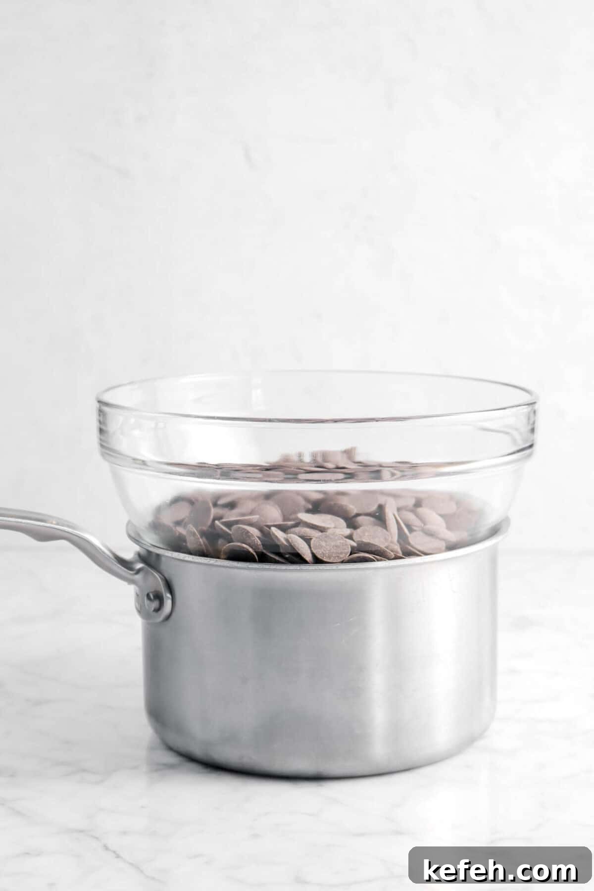 chocolate in a glass bowl on a small pot.
