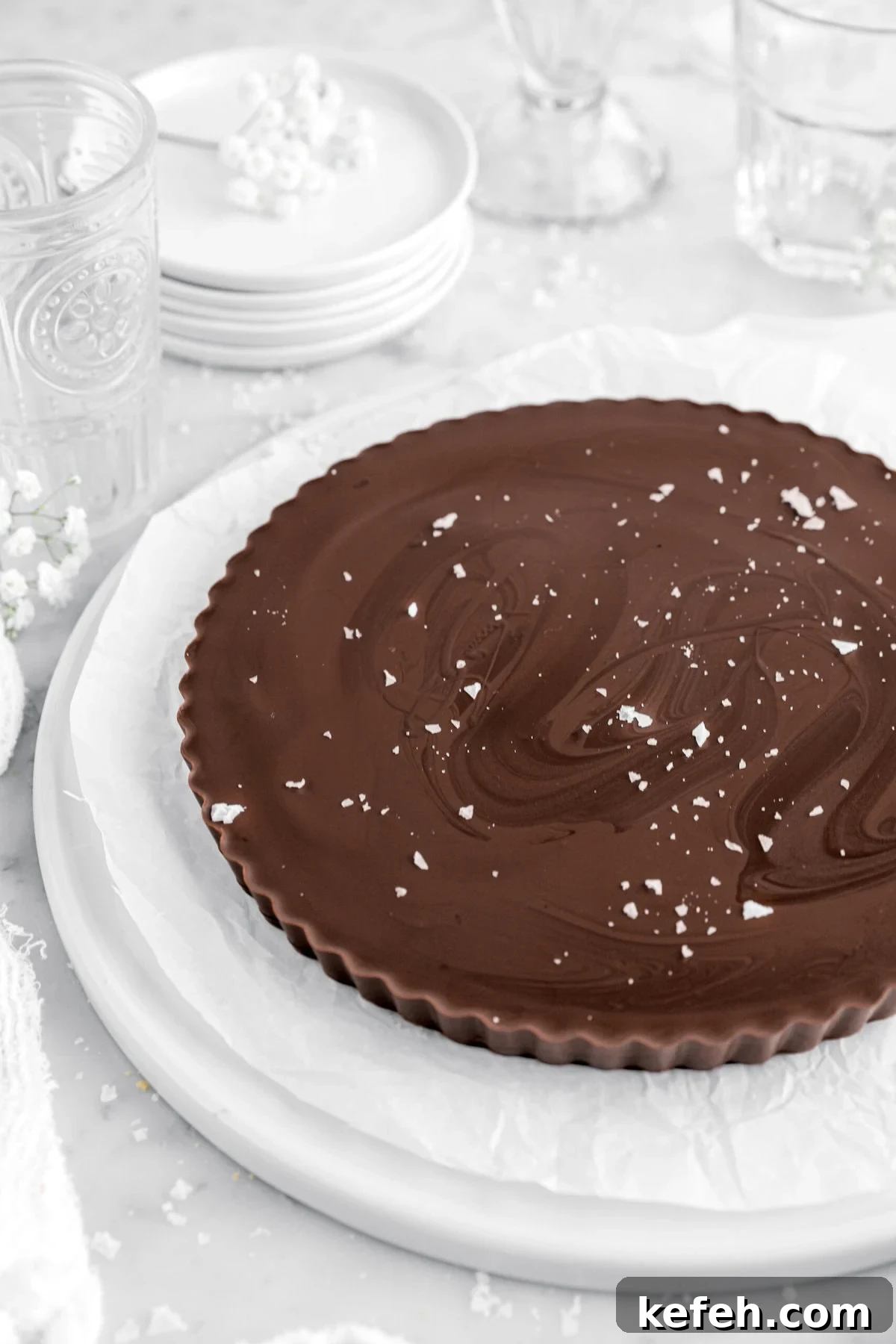 cropped close up of giant peanut butter cup with flaked salt on top.