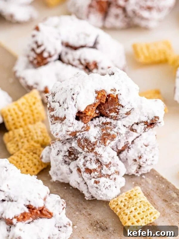 Chewy Cowboy Cookies with Oats, Chocolate & Pecans 14 picture of muddy buddy cookies stacked on a wood cutting board