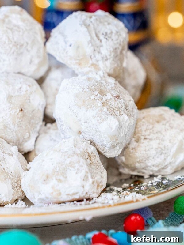 Chewy Cowboy Cookies with Oats, Chocolate & Pecans 18 picture of russian tea cakes stacked on a plate