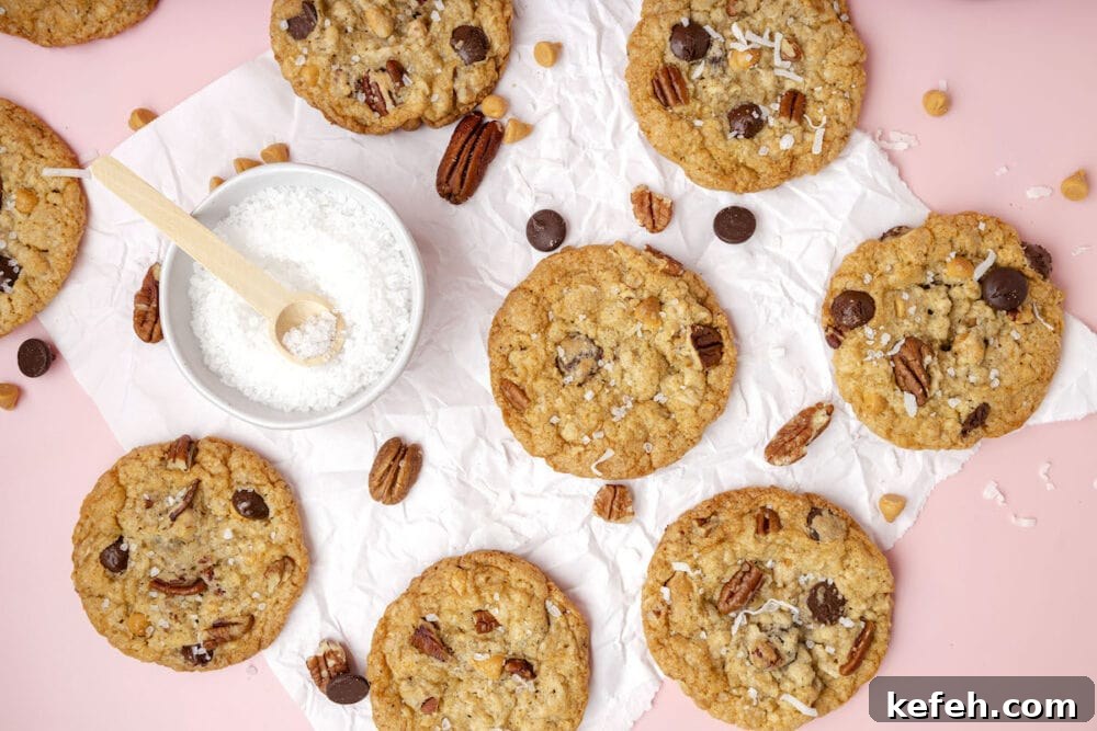 Chewy Cowboy Cookies with Oats, Chocolate & Pecans 22 picture of a chocolate chip and oatmeal cookie with butterscotch chips, pecans, coconuts, and salt on top