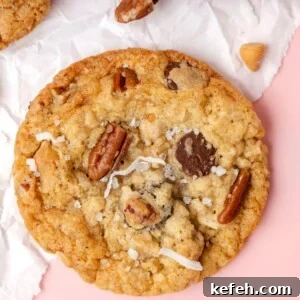 Chewy Cowboy Cookies with Oats, Chocolate & Pecans 24 picture of a chocolate chip and oatmeal cookie with butterscotch chips, pecans, coconuts, and salt on top