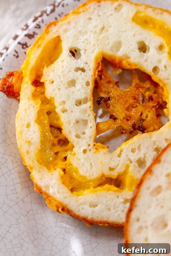 Loaded Stuffed Bagel Recipes: Creative Fillings and Toppings 4 a cut open bagel showing the inside cheese ribbon.