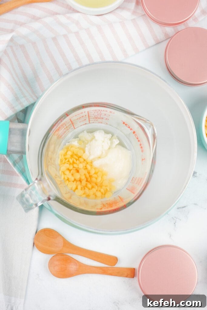 Measuring cup placed in a saucepan with ingredients melting for the dog paw balm.