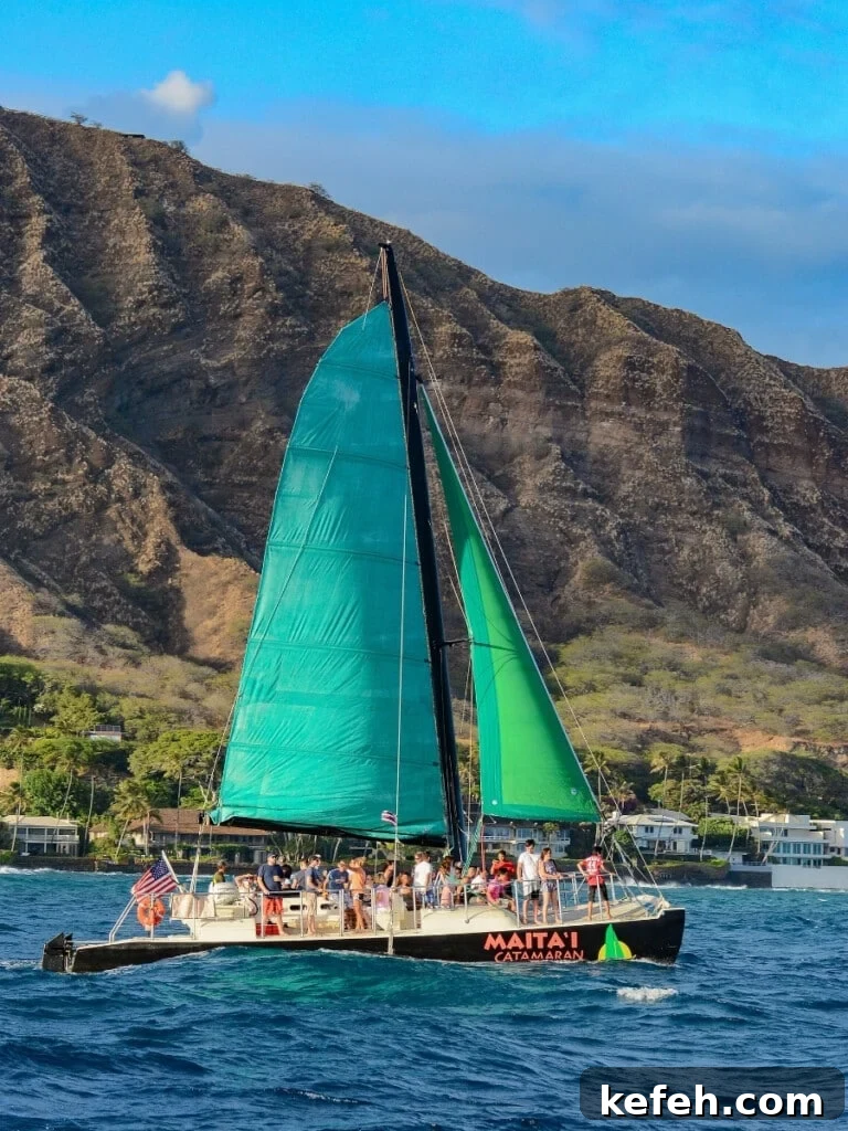 100+ Waikīkī Activities: Local Favorites and Insider Tips 2 The Mai Tai Catamaran Cruise off Waikīkī Beach, with a Lēʻahi (Diamond Head) backdrop in Oʻahu, Hawaiʻi.
