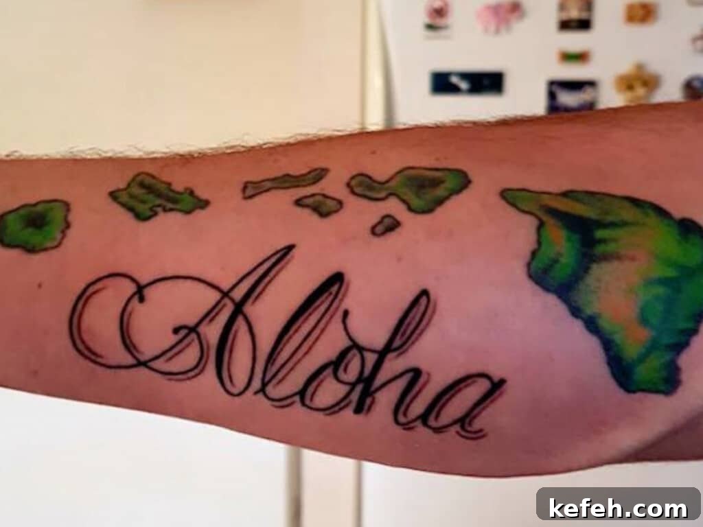 100+ Waikīkī Activities: Local Favorites and Insider Tips 14 Close up of a tattoo on forearm showcasing "Aloha" in script with a map of the green Hawaiian Islands.