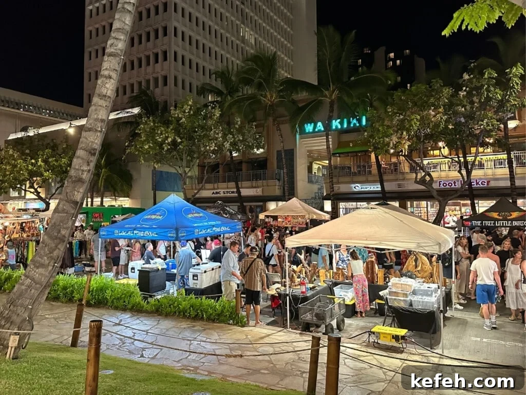 100+ Waikīkī Activities: Local Favorites and Insider Tips 16 A busy block party/street festival happening at night on Kalākaua Avenue in Waikīkī.