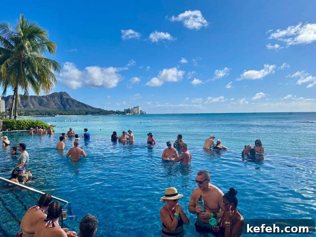 100+ Waikīkī Activities: Local Favorites and Insider Tips 6 People relaxing in Sheraton Waikiki's adults-only infinity pool with a view of Diamond head and the ocean in the background.