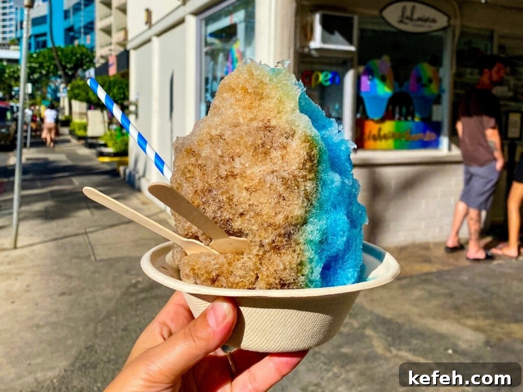 100+ Waikīkī Activities: Local Favorites and Insider Tips 8 Hand holding out colourful Shave ice in front of the Lahaina Shave Ice stall.