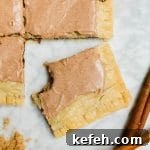 A giant pop tart with brown sugar cinnamon filling and cinnamon glaze with a bite out of a slice.