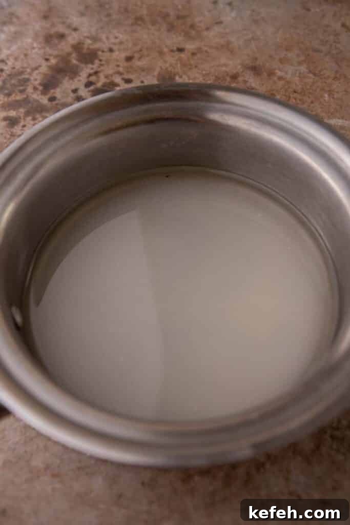 Homemade Caramel Coffee Syrup Recipe for Café-Quality Drinks 4 Sugar and water in a pot