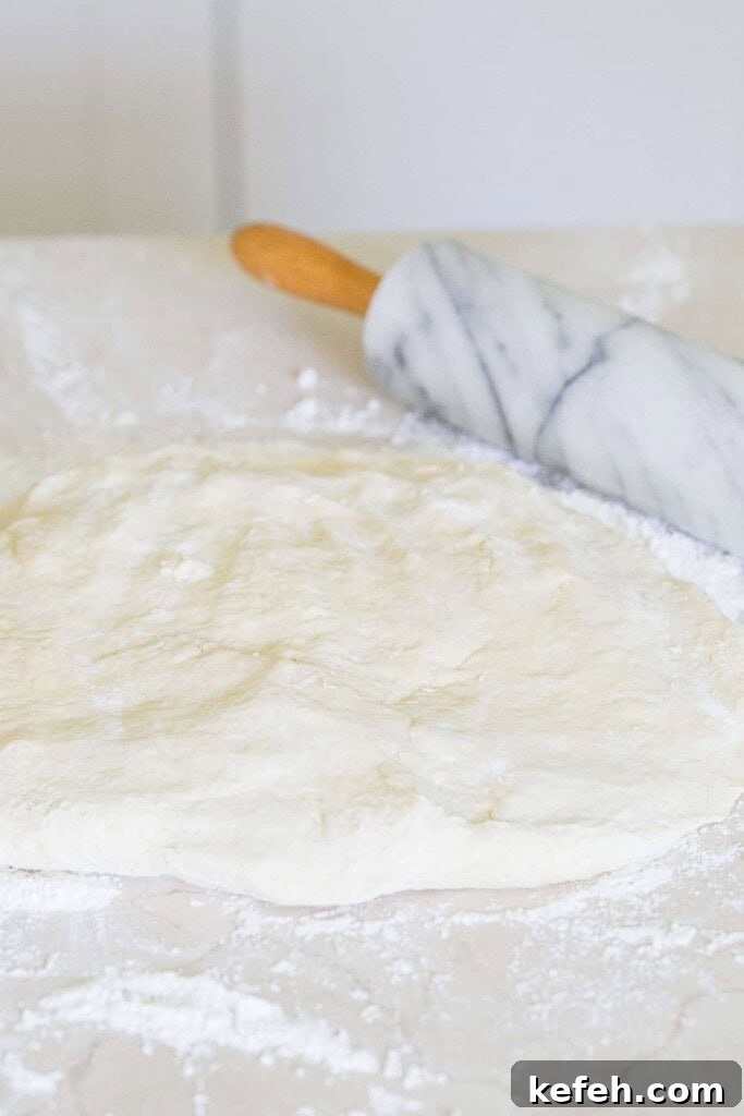 Authentic New Orleans Beignets Recipe for Perfect Cafe-Style Treats 3 Rolling beignet dough.