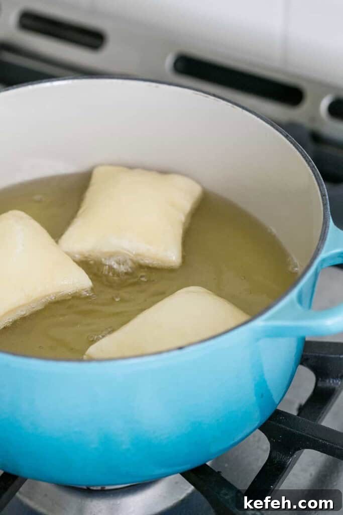 Authentic New Orleans Beignets Recipe for Perfect Cafe-Style Treats 5 Frying beignets in oil.