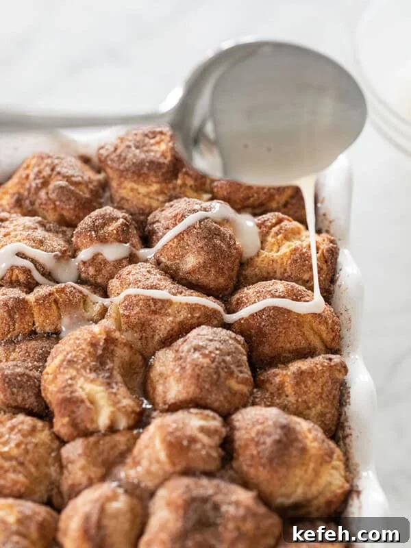 Authentic New Orleans Beignets Recipe for Perfect Cafe-Style Treats 9 pouring glaze over baked monkey bread