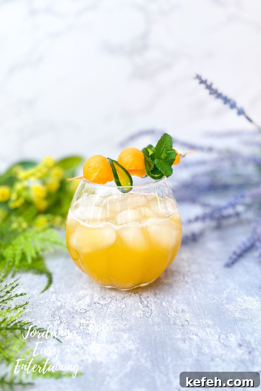 a glass of cucumber cantaloupe water also know as cucumber cantaloupe agua fresca