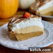 A slice of pumpkin cream pie on a plate.