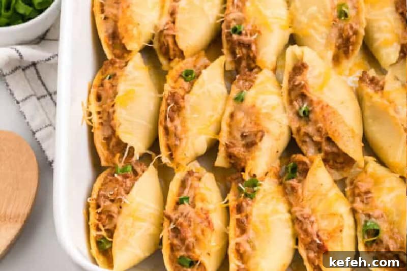 30 Ground Beef Dinner Recipes for Quick Family Meals 13 Taco Stuffed Shells in a white baking dish.