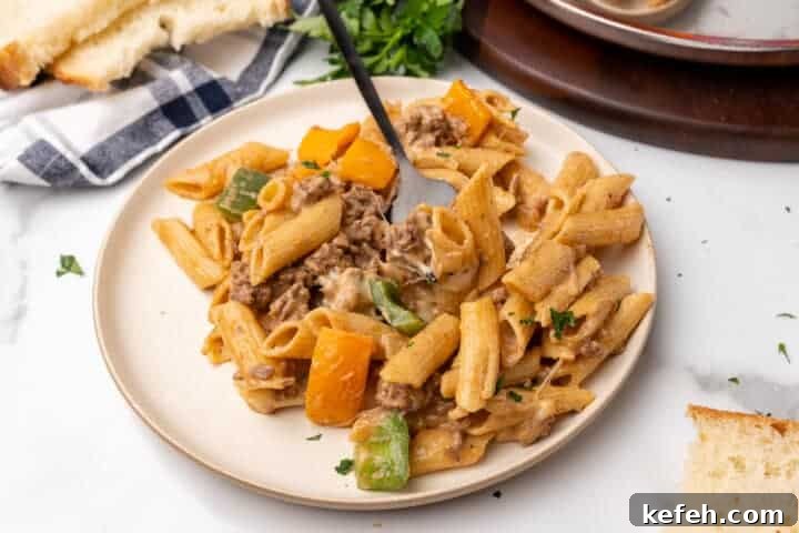 30 Ground Beef Dinner Recipes for Quick Family Meals 16 Philly Cheesesteak Pasta served on a white plate.