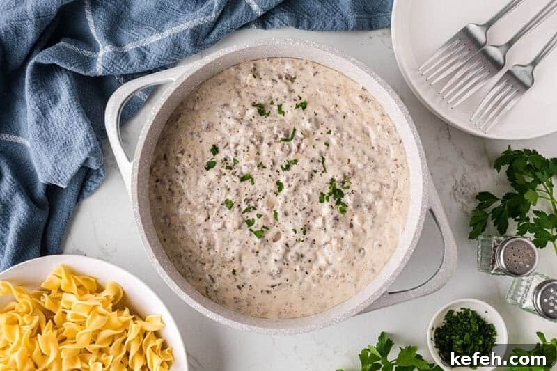 30 Ground Beef Dinner Recipes for Quick Family Meals 23 ground beef stroganoff served in a large white pot.